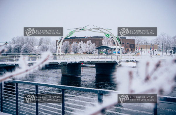 Janesville Pedestiran bridge in the winter framed by frosted branches